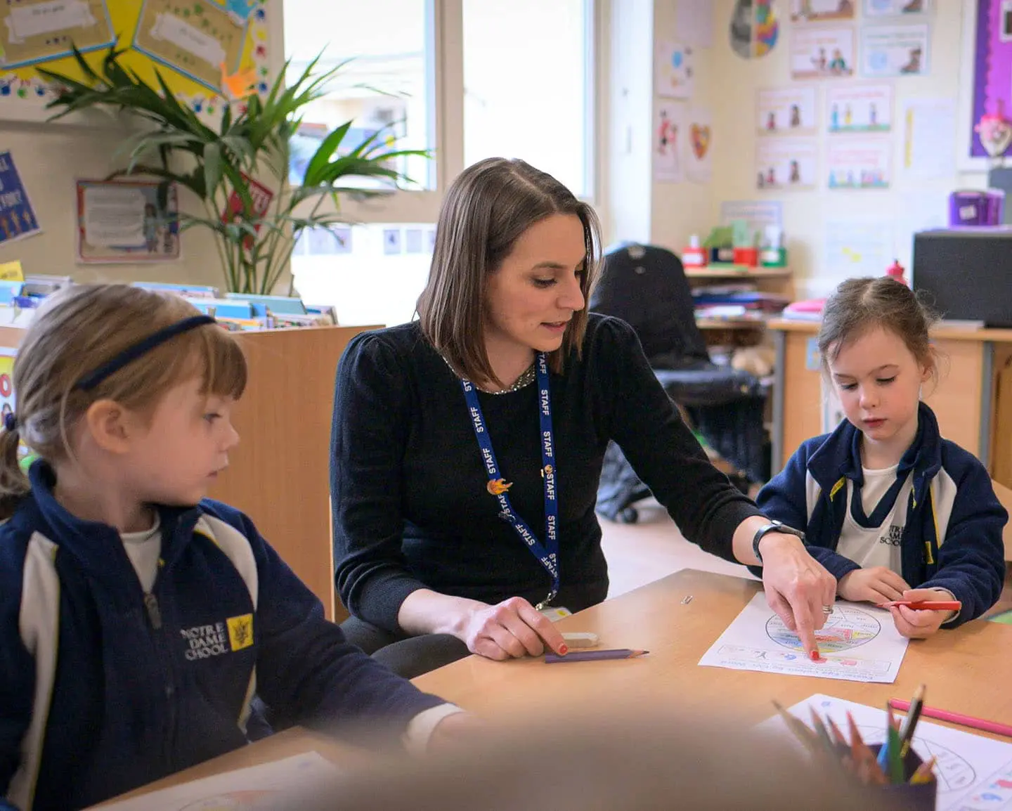 img - teacher teaching focused reception children